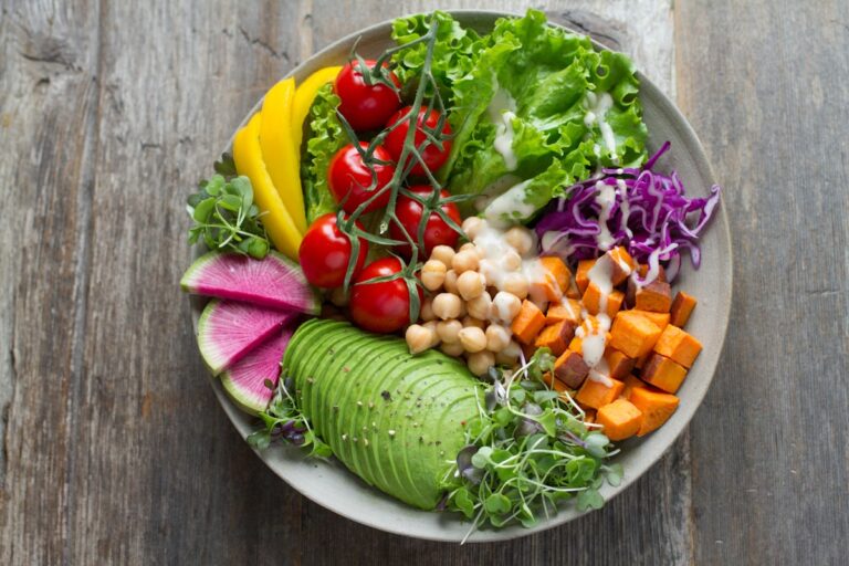 Colorful assortment of fresh healthy weight loss foods including vegetables salmon and eggs