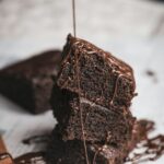 Warm chocolate lava cake with molten center flowing out served with vanilla ice cream